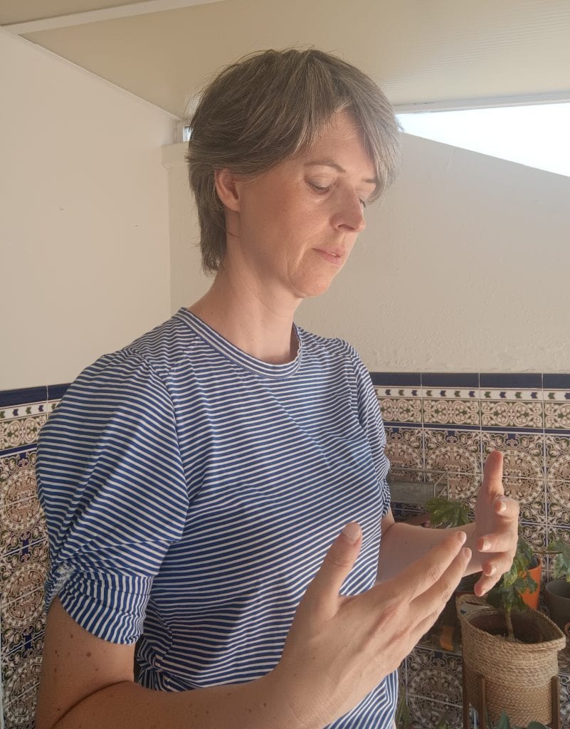 Catelijne Coopmans in a posture of "holding back", with hands coming in towards the chest.